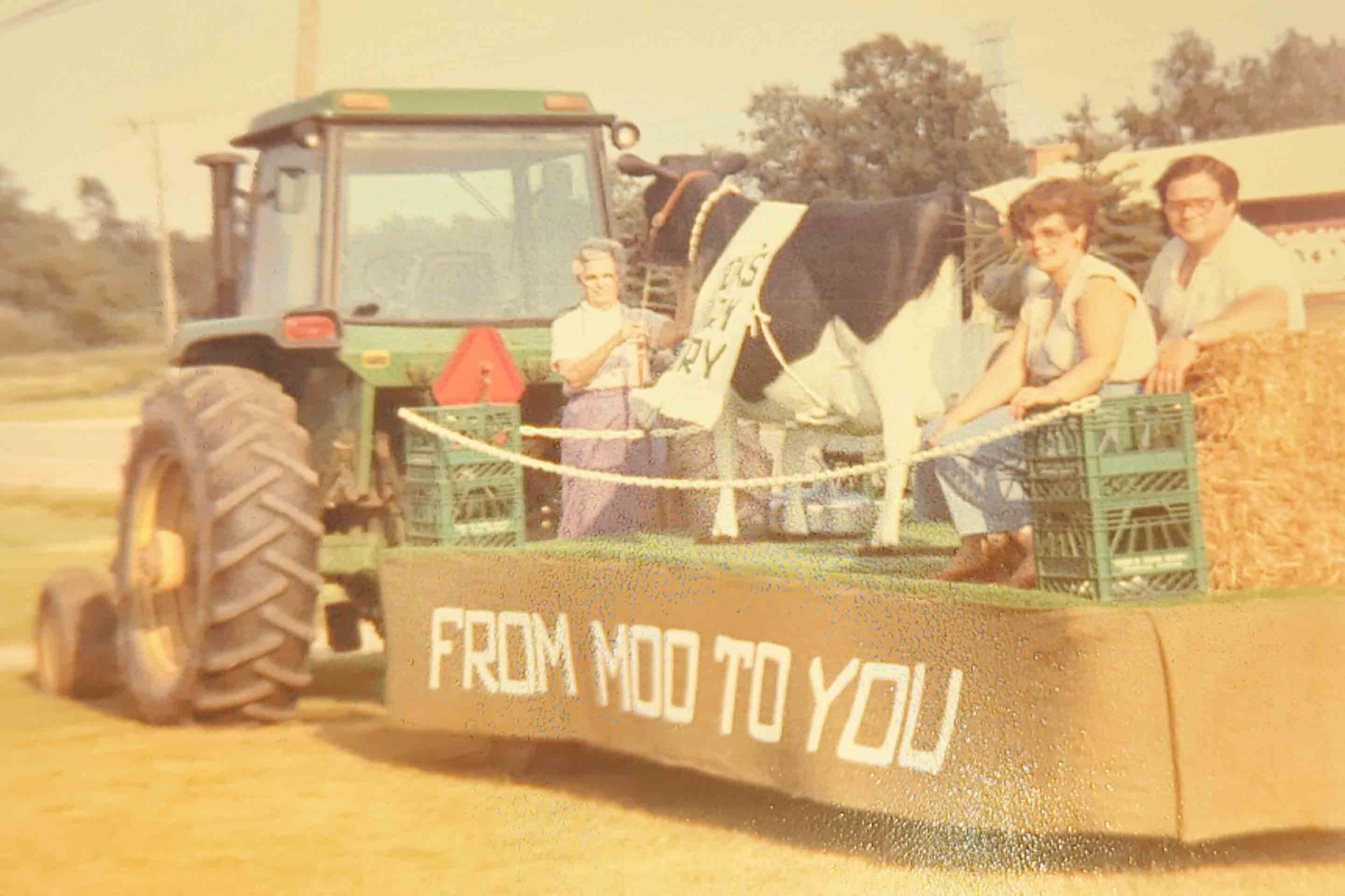 Cooks Farm Dairy Float Reading "From Moo To You" in Clarkston, Michigan Parade 1980's